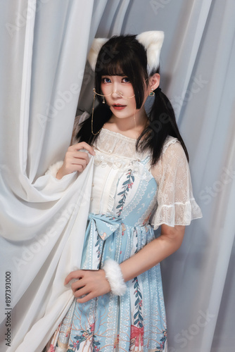 A warm indoor moment with a girl holding glowing lights and wearing cat ears