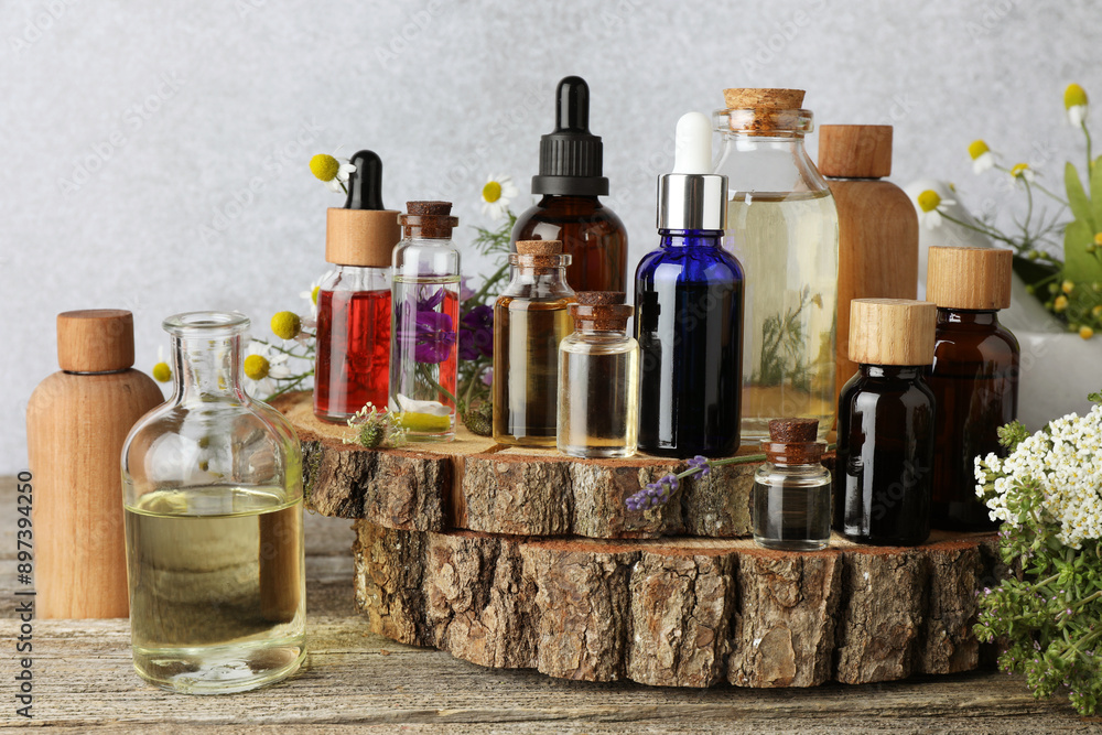 Aromatherapy. Different essential oils and flowers on wooden table Aromatherapy. Different essential oils and flowers on wooden table