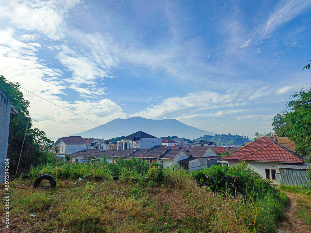 Obraz premium housing complex with a beautiful mountain background in the morning blue sky
