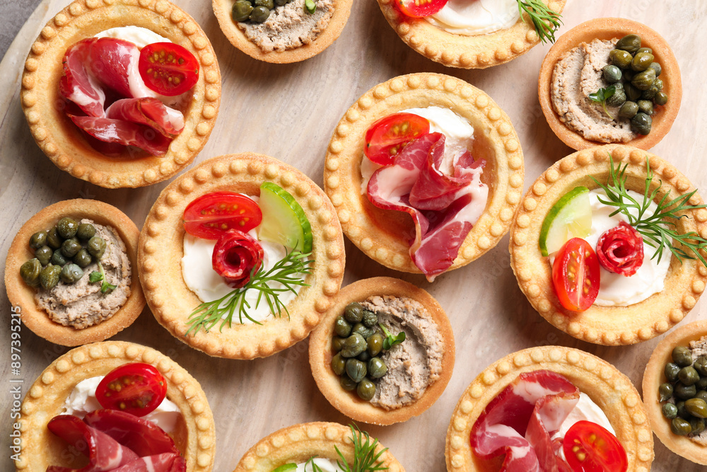 Delicious canapes with jamon, pate and dry smoked sausages on table, flat lay Delicious canapes with jamon, pate and dry smoked sausages on table, flat lay