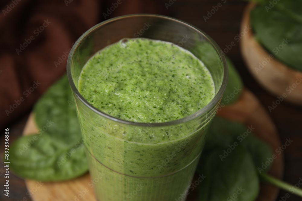 Tasty green smoothie in glass on table, closeup Tasty green smoothie in glass on table, closeup
