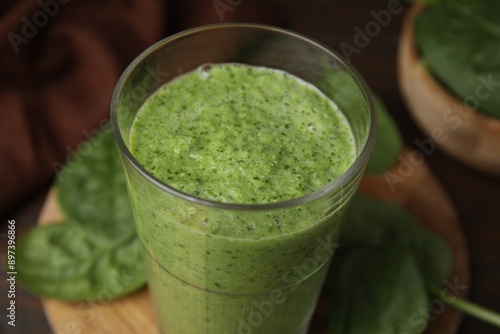 Tasty green smoothie in glass on table, closeup