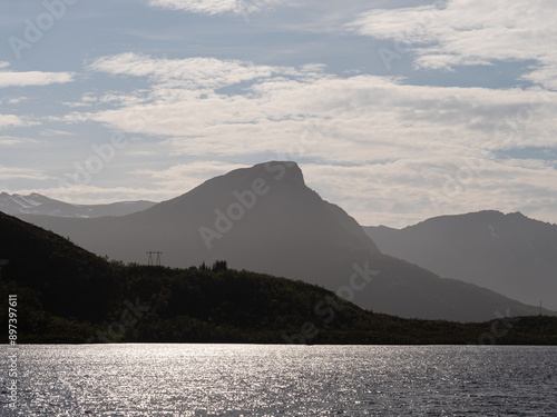 Sunlit water with mountains