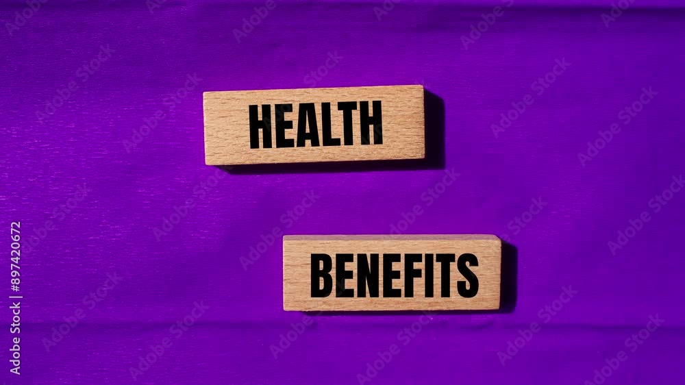 Health benefits message writing on wooden blocks on purple background Health benefits message writing on wooden blocks on purple background