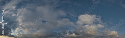 Russia, south of Western Siberia. Panoramic view of the evening sky with the setting sun and colorful clouds.