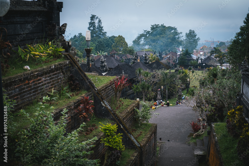 A view overlooking the Besakih Temple grounds with lush vegetation and traditional Balinese architecture. A view overlooking the Besakih Temple grounds with lush vegetation and traditional Balinese architecture.