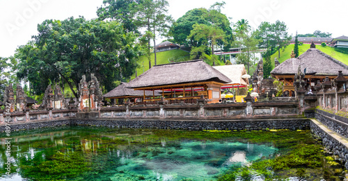 A Balinese temple with a reflection pond in front, highlighting the serene and sacred ambiance. photo