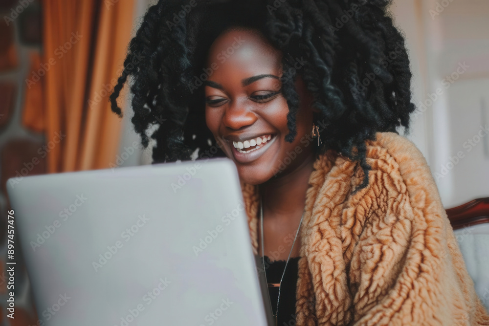 photo of a happy African American woman working on laptop, white natural light photo of a happy African American woman working on laptop, white natural light