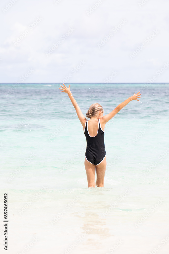 Excited young girl having fun at the beach during summer Excited young girl having fun at the beach during summer