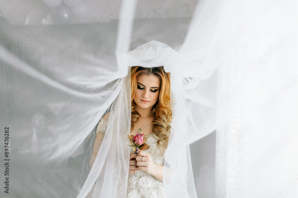 A woman is wearing a veil and holding a rose. The veil is white and covers her face A woman is wearing a veil and holding a rose. The veil is white and covers her face