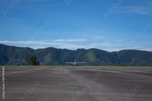 A small turboprop aircraft lands at a remote airport