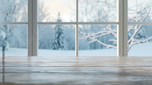 A window view of a snowy landscape with a tree in the background photo