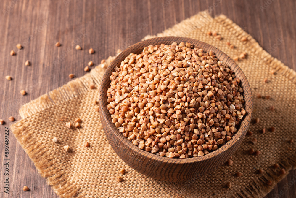 Buckwheat groats on wooden background. Healthy cereal concept. Buckwheat groats on wooden background. Healthy cereal concept.