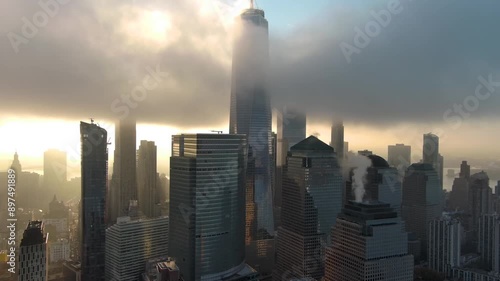Aerial view of the downtown New York city skyline at sunset in the fog. One world trade center.