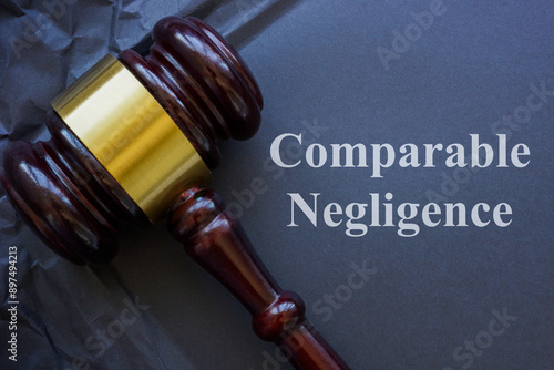 Comparable negligence concept. Gavel and crumbled dark paper.