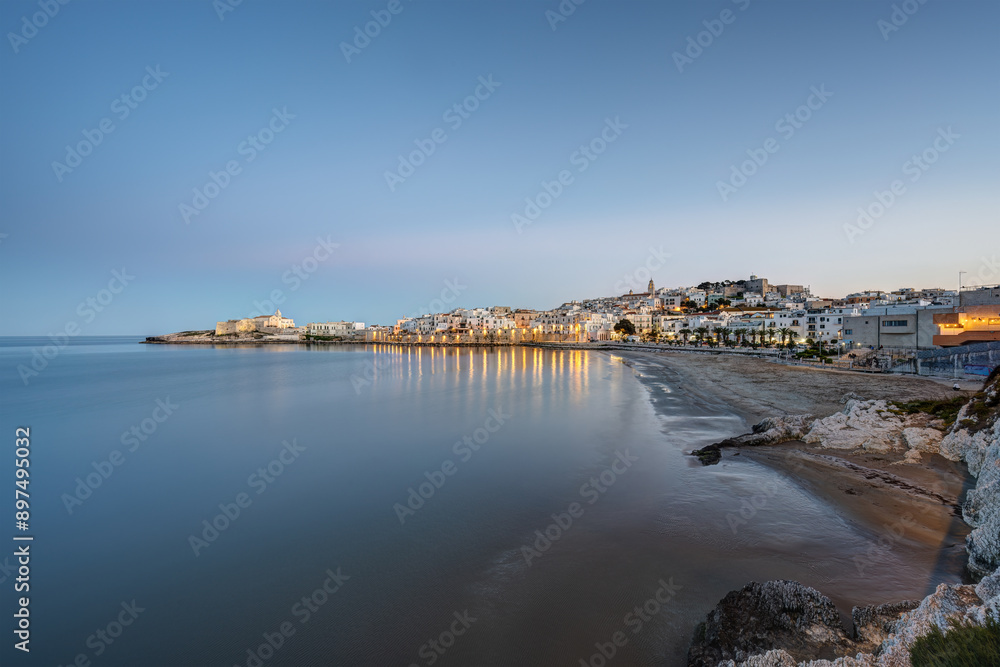 The beautiful city of Vieste and the Adriatic Sea in Puglia, Italy, at dusk The beautiful city of Vieste and the Adriatic Sea in Puglia, Italy, at dusk