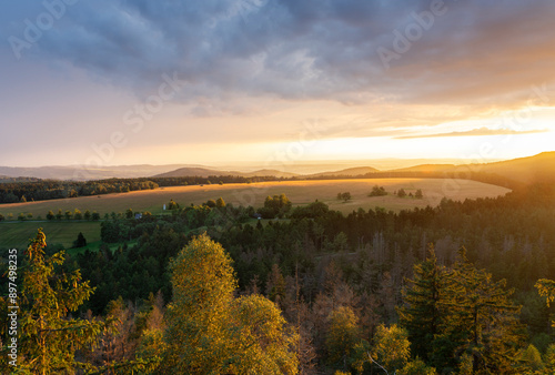 Sunset over the table mountains. Kłodzka Valley, Kudowa Zdroj area. Amazing colors during sunset: orange, yellow, green and clouds adding extraordinary charm photo