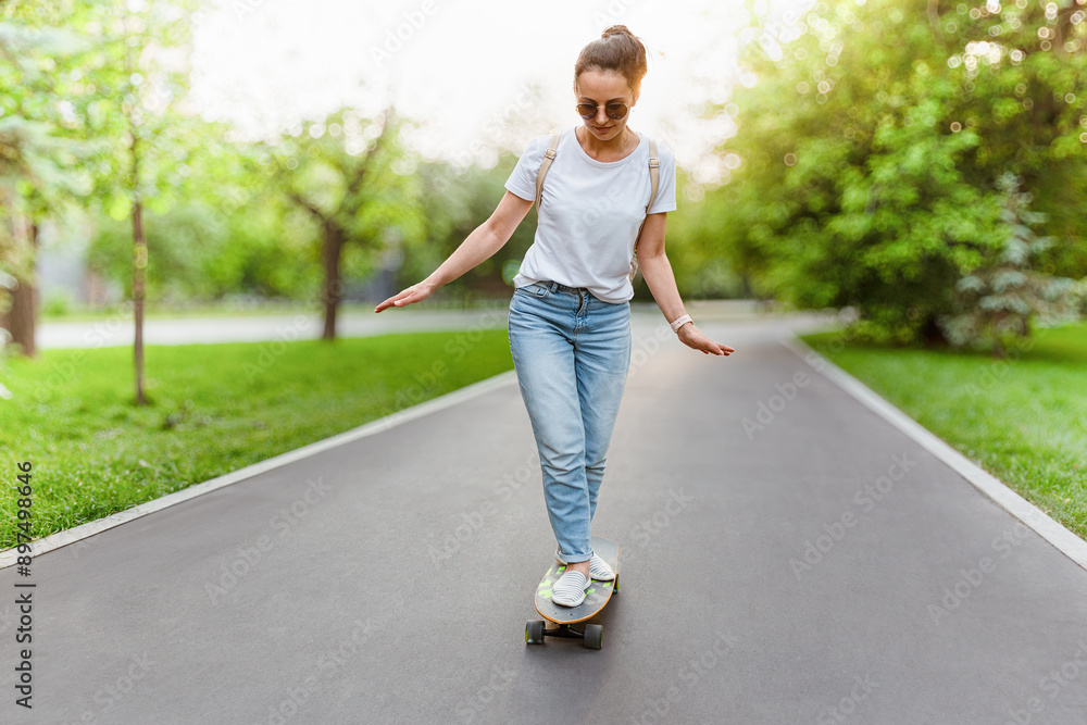Woman Skateboarding In A Park Sunny Day Woman Skateboarding In A Park Sunny Day