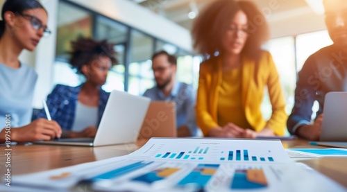 Diverse business team discussing financial data during a meeting in the office, concept for group collaboration or market analysis.
