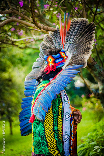 Sao Paulo, SP, Brazil - February 23 2020: Vertical photograph of an indigenous person from the Brazilian Amazon with a headdress made of colorful feathers.