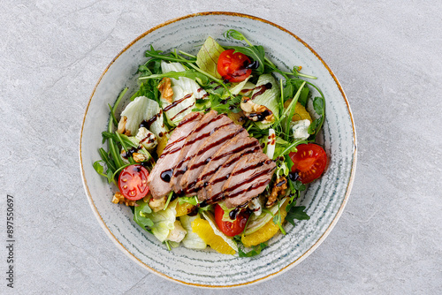 Peking duck on salad with orange on gray background for delivery restaurant menu