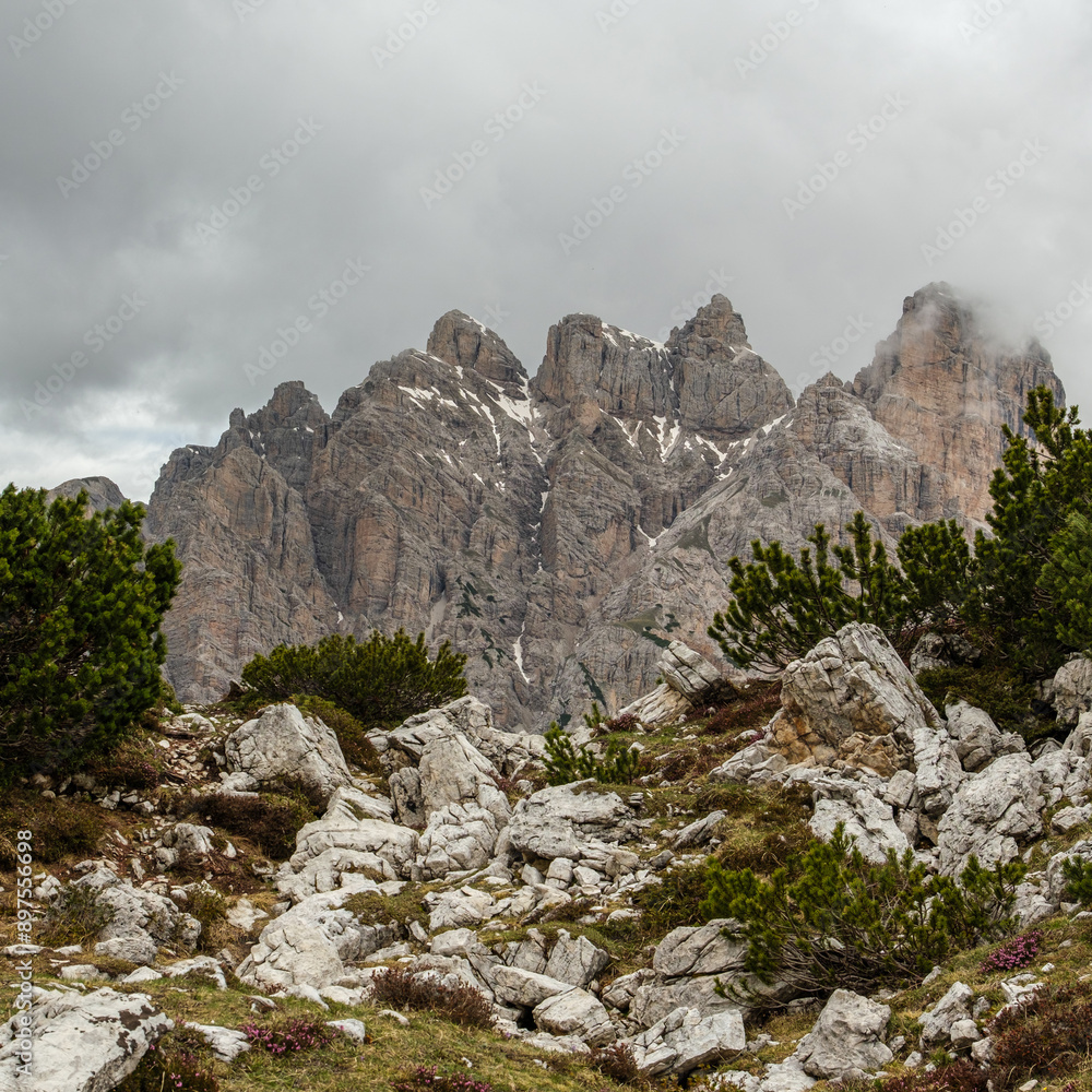 Fototapeta premium Snow and Clouds: Tre Cime Circuit Trail with Dolomite Summits