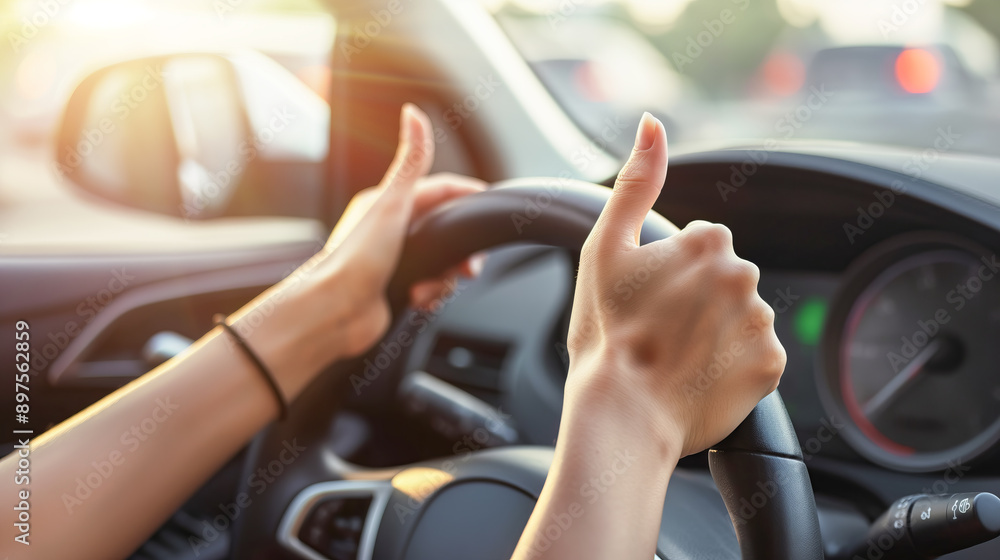 Close-up of a woman's hands holding the steering wheel in a new car Close-up of a woman's hands holding the steering wheel in a new car