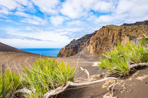 Rocks and cliffs at Capelinhos peninsula with volcanic landscape and ocean in background, Faial island, Azores, Portugal photo