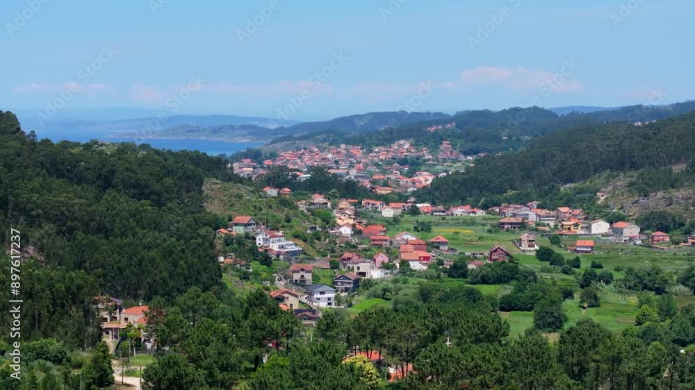 Drone showing Remote Settlements Amidst Dense Mountains on a sunny day in Cangas, A Coruna, Spain Drone showing Remote Settlements Amidst Dense Mountains on a sunny day in Cangas, A Coruna, Spain