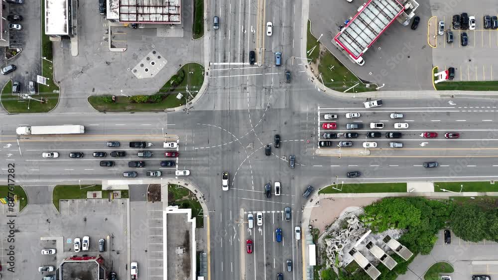 Aerial shot of a bustling traffic intersection, showcasing the dynamic flow of vehicles at the day Aerial shot of a bustling traffic intersection, showcasing the dynamic flow of vehicles at the day