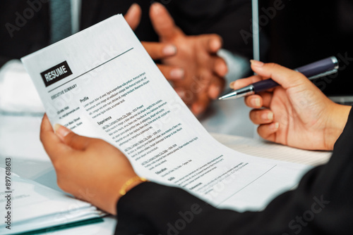 Bilde på lerret Human resources department manager reads CV resume document of an employee candidate at interview room