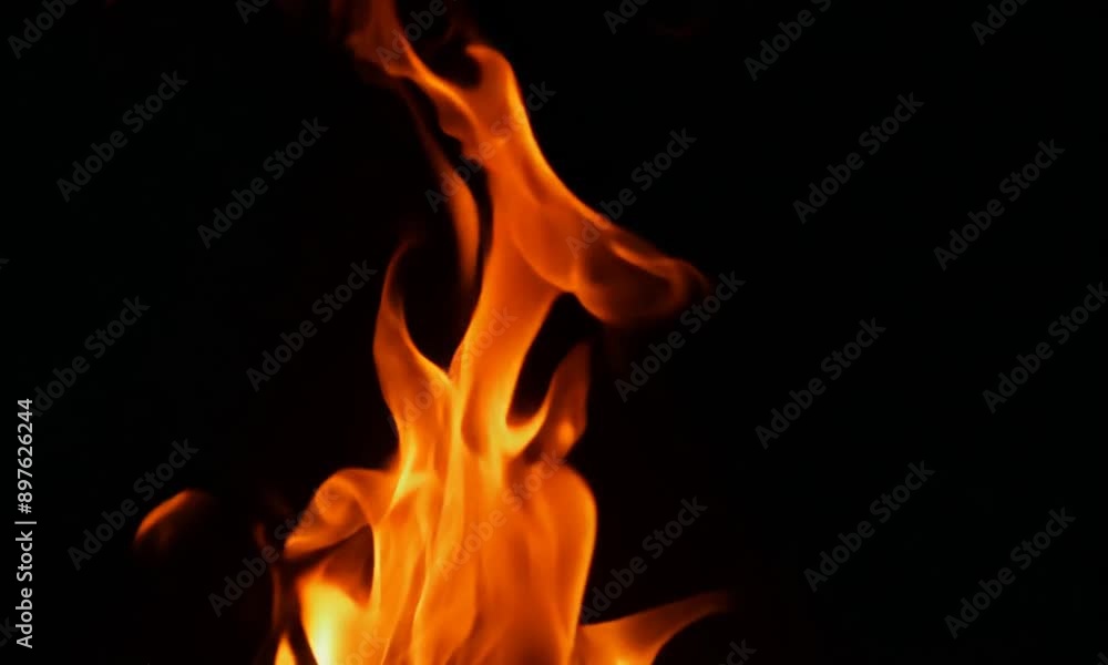 Flames rising up on a black background, slow motion 4K video Flames rising up on a black background, slow motion 4K video