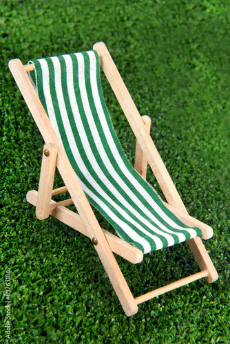 close up of chaise lounge on green grass mini