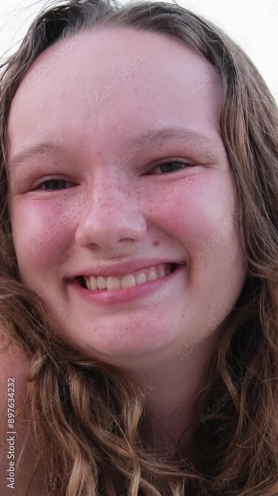 Tight smile. Relaxing on beach emotions of young girl burnt skin red cheeks wet hair. swimming summer vacation. Woman on background of lake sea river Tight smile. Relaxing on beach emotions of young girl burnt skin red cheeks wet hair. swimming summer vacation. Woman on background of lake sea river