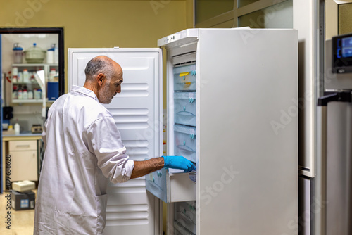 Scientist checking contents of refrigerator in laboratory