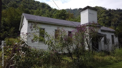 Houses and streets in the abandoned coal mining town with a railroad through the middle of it in southern West Virginia. photo