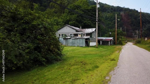 Houses and streets in the abandoned coal mining town with a railroad through the middle of it in southern West Virginia. photo