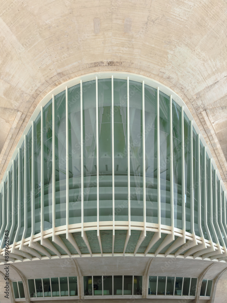 Obraz premium Contemporary structure with a large glass facade and distinctive architectural elements, emphasizing modern design, urban innovation, and advanced engineering techniques.