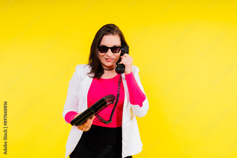 Photo portrait of plump female holding phone isolated on yellow background Photo portrait of plump female holding phone isolated on yellow background
