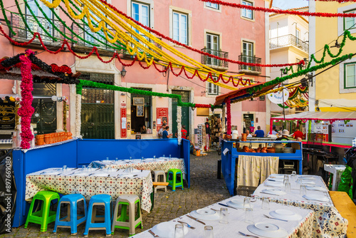 Quadro em tela Tables of restaurant in Alfama district old town during Sardine Festival of St A