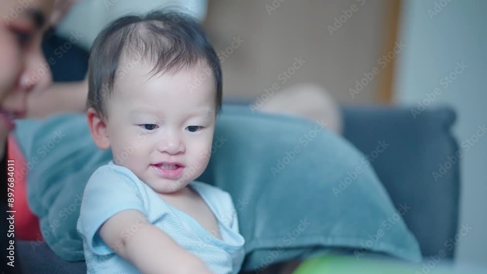 Asian child and his baby sitter reading story book together at home couch, child story telling method, cartoon books, kids analog entertainment, learning from reading, childhood home education