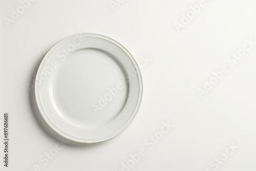 A simple white plate ready for serving, top view 