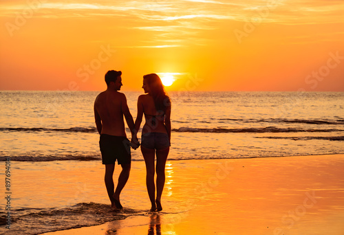 Silhouette of romantic loving couple on beach at sunset