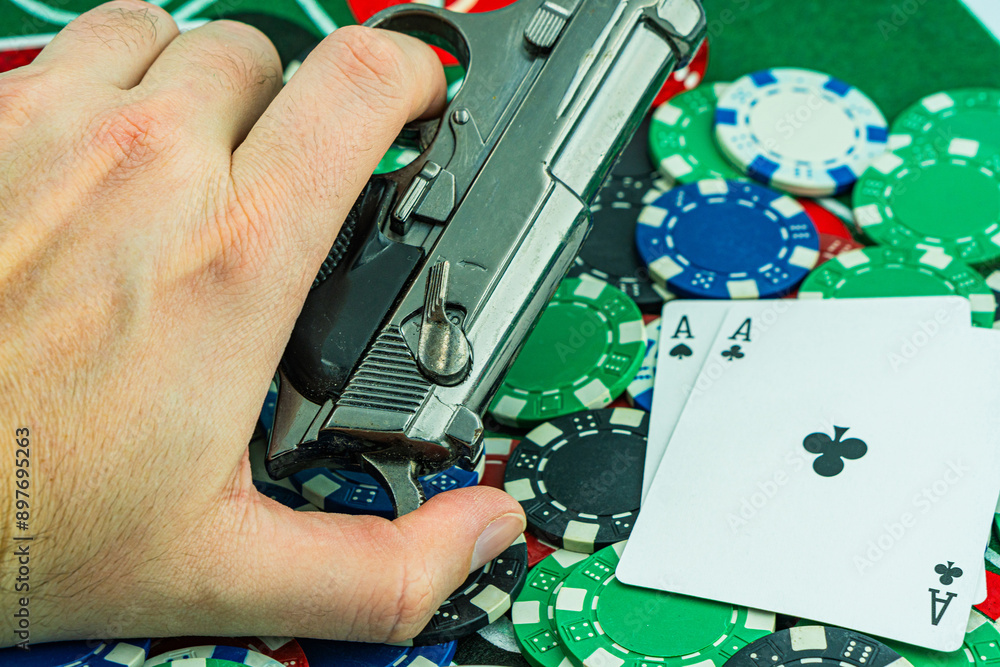 Fototapeta premium Handcuffs and a gun on a poker table - casino crime concept, underground casinos. illegal games, gambling concept. set of playing cards with dices, money and chips, on table. Casino concept, games.