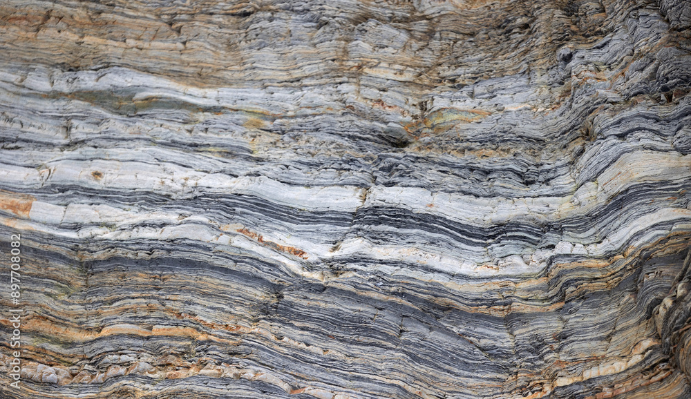 Close-up of layered rock formations with distinct horizontal lines and varied colors Close-up of layered rock formations with distinct horizontal lines and varied colors