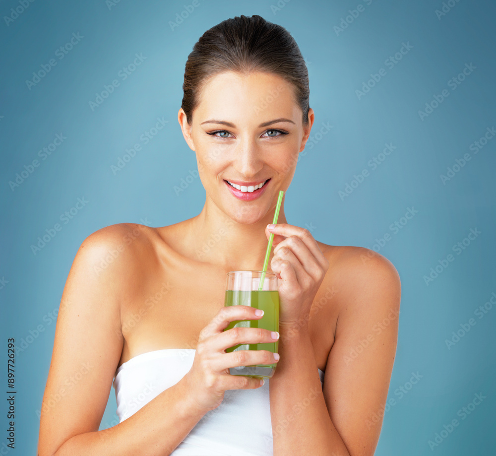 Vitamin c, portrait and woman in studio with smoothie for minerals, detox and healthy nutrition on blue background. Smile, diet and female model with glass for wellness, antioxidants and fresh juice Vitamin c, portrait and woman in studio with smoothie for minerals, detox and healthy nutrition on blue background. Smile, diet and female model with glass for wellness, antioxidants and fresh juice