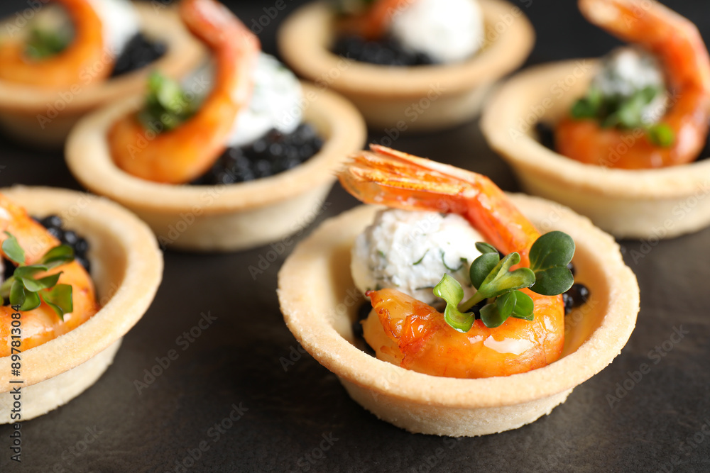 Delicious canapes with shrimps and black caviar on table, closeup Delicious canapes with shrimps and black caviar on table, closeup