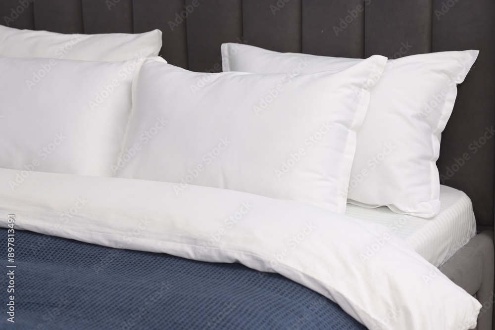 Many soft pillows on bed at home, closeup Many soft pillows on bed at home, closeup