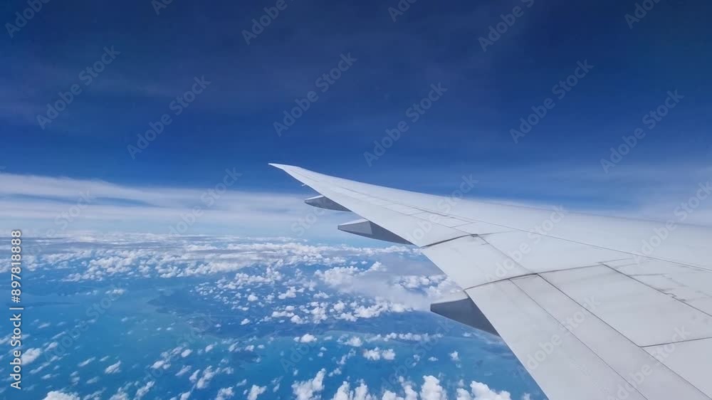 Passenger view from airplane window flying above the sky Passenger view from airplane window flying above the sky