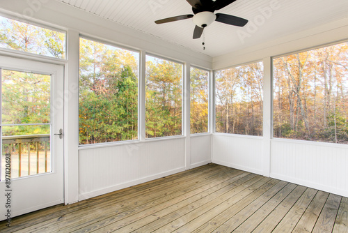 Slika na platnu Autumn Covered Porch With A Fan Overlooking A Lush Garden And Greenery